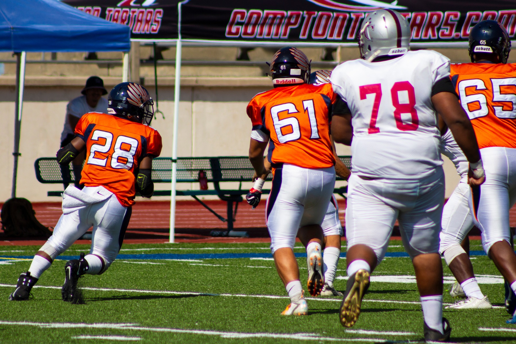 Running back Nick French (28) gets key blocking from Jeffery Garcia (61) and Richard Miranda (65). Image: Treyvon Watts-Hale