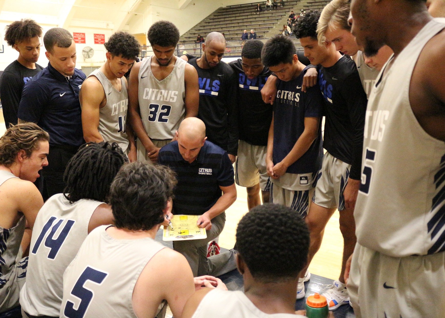 Head Coach Brett Lauer draws up a play for his players.