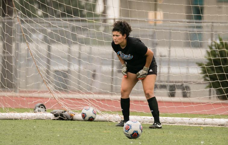 Sophomore Goalkeeper Olivia Handy focuses on her pregame routine. Image credit: Ampie Photography